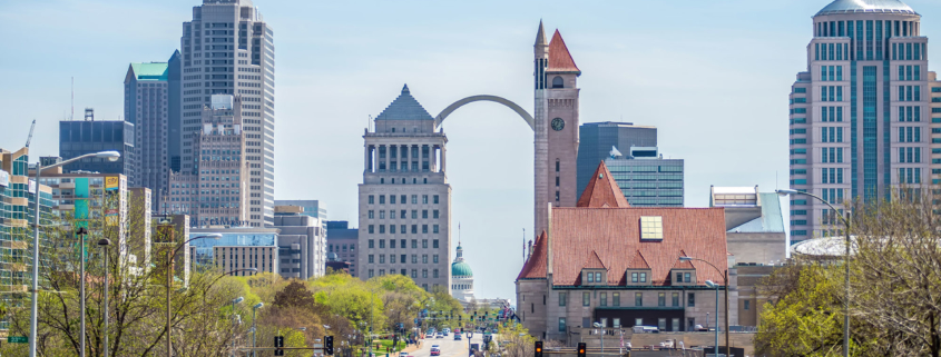 view of St. Louis skyline from street with Arch in center view