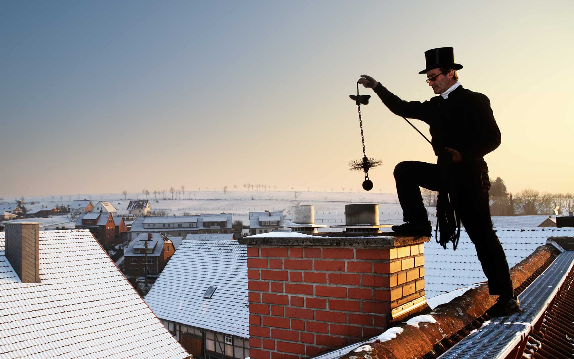 Old Timey Chimney Sweep On Roof 