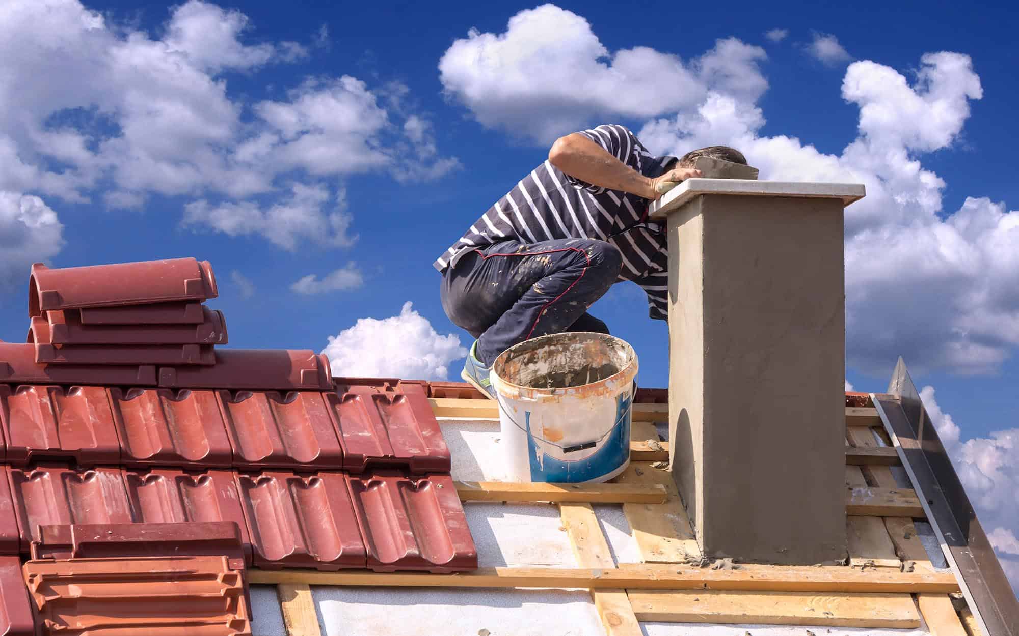 Image Of A Worker Repairing A Chimney With Sealant. 