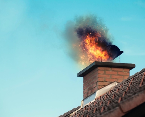 Image of a chimney with fire coming out the top.