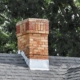 An old chimney on a shingles rooftop