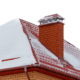 A chimney on a roof with snow on it