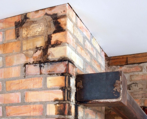 Cracked and leaking brick chimney